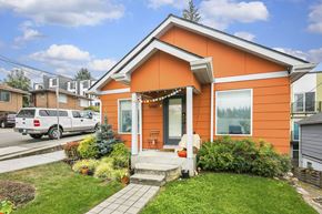 Seattle apartment for rent - an orange house with a white truck parked in front of it