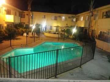 Van Nuys apartment for rent - the pool is lit up at night at the resort
