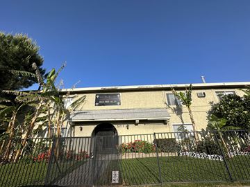 N. Hollywood apartment for rent - an old building with a fence and a sign on it