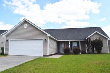 Effingham house for rent - a house with a white garage door and a lawn