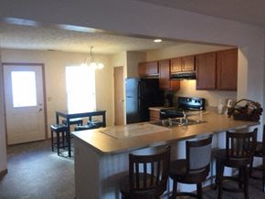 Cleves apartment for rent - a kitchen with a bar and a dining area