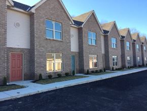 Cleves apartment for rent - a row of brick houses with a red door