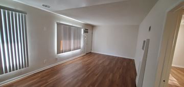 Valley Village apartment for rent - an empty living room with wood flooring and a window