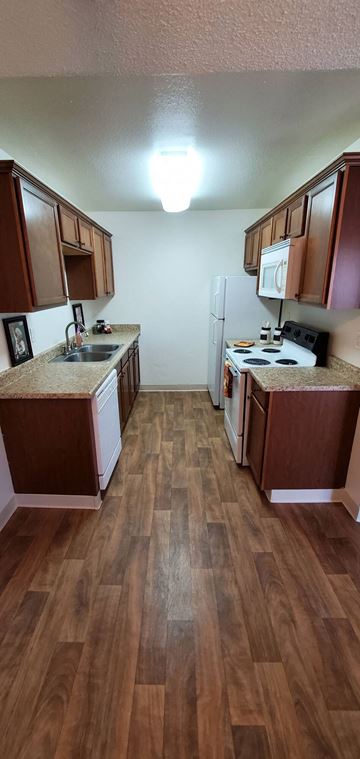 El Cajon apartment for rent - a kitchen with wooden floors and wooden cabinets