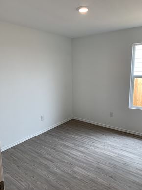 San Antonio house for rent - an empty room with white walls and wooden floors