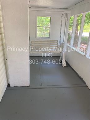 Andrews house for rent - A room with a window and a door, managed by Primacy Property Management LLC.