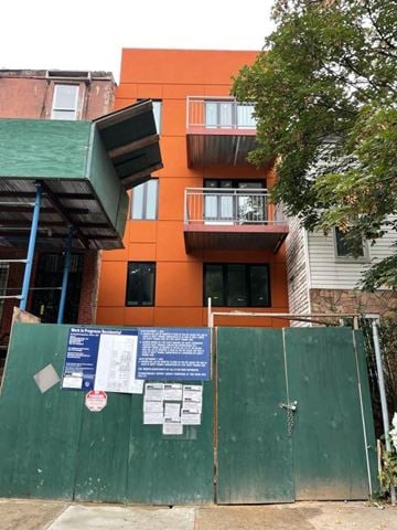 Brooklyn apartment for rent - an orange building with a fence in front of it