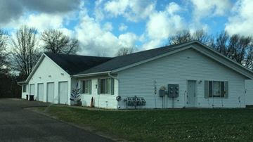 Menomonie apartment for rent - a white church with a black roof and a lawn