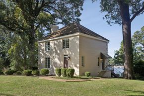 Newport News house for rent - A small white house with a brown door and a brown roof.