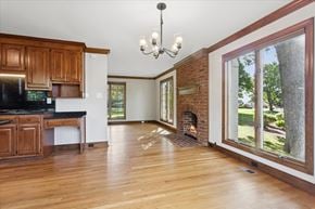 Newport News house for rent - A large open living room with a fireplace and a chandelier.