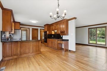 Newport News house for rent - A kitchen with wooden cabinets and a black countertop.
