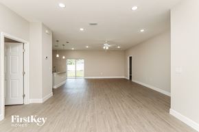 Palm Bay house for rent - A spacious room with wooden flooring and a ceiling fan.
