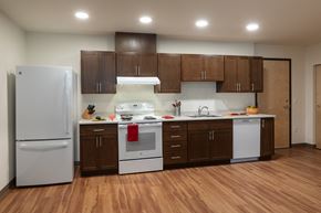 Seattle apartment for rent - a kitchen with white appliances and brown cabinets