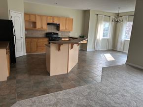 Edmonton house for rent - an empty kitchen with an island in the middle of it