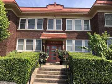 Dallas apartment for rent - a red brick house with a red door and stairs in front of it