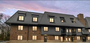 Troy apartment for rent - a large brick building with a black roof