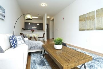 Aberdeen apartment for rent - A white couch with blue pillows sits in a living room with a wooden coffee table.