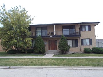 Lynwood apartment for rent - the front of an apartment building with trees and a sidewalk