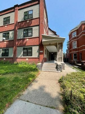 Philadelphia apartment for rent - a large brick building with a porch and a sidewalk