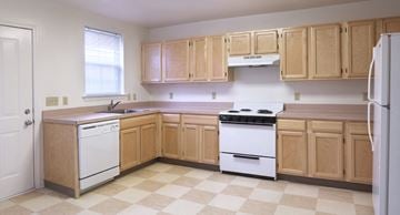 Bridgeton apartment for rent - A kitchen with wooden cabinets and a checkered floor.