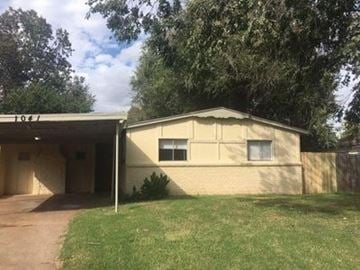 Oklahoma City house for rent - A beige house with a white door and windows.