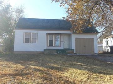 Oklahoma City house for rent - a small white house with a yard and a garage