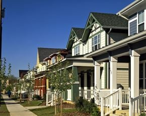 Bridgeton townhouse for rent - a row of green and white houses on the side of a sidewalk