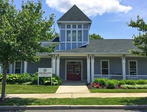 Bridgeton townhouse for rent - a building with a red door and a sign in front of it