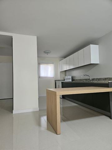 Mangilao apartment for rent - A kitchen with a wooden island in the middle of the room.