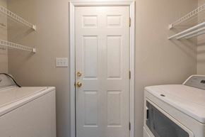 Fayetteville house for rent - A white door is in the middle of a laundry room.