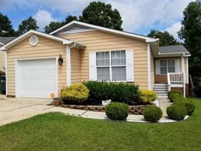 Fayetteville house for rent - A house with a white garage door and a brown roof.