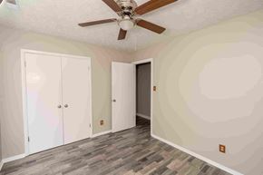 Fayetteville house for rent - A room with a ceiling fan and three doors.