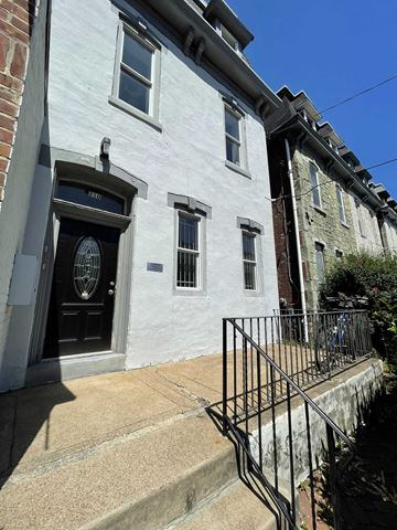 Philadelphia apartment for rent - a white building with a black door and stairs