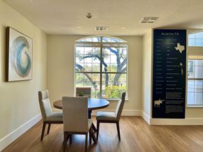 Austin apartment for rent - a dining room with a table and chairs and a large window