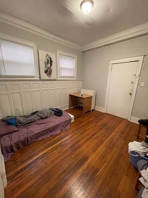 Philadelphia apartment for rent - a bedroom with a bed and a wooden floor