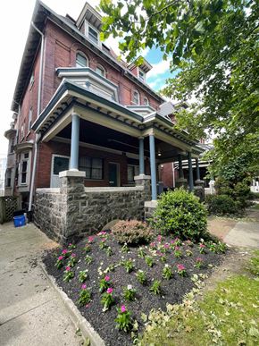 Philadelphia apartment for rent - a house with a flower garden in front of it