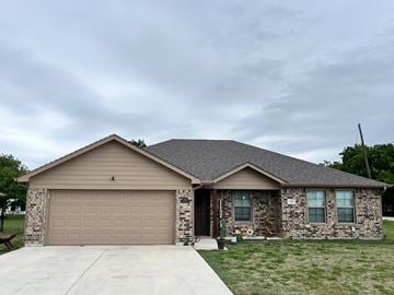 Ponder house for rent - A house with a garage and a driveway.