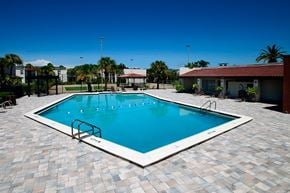 Kissimmee apartment for rent - a large swimming pool with a house in the background