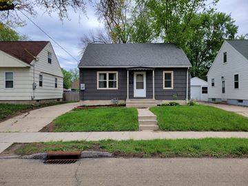 Rochester house for rent - a gray house with a sidewalk in front of it