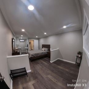 Cleveland apartment for rent - a bedroom with a bed in a room with white walls and wood floors