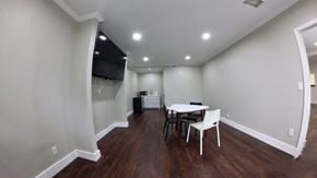 Cleveland apartment for rent - a dining room with a table and chairs and a tv