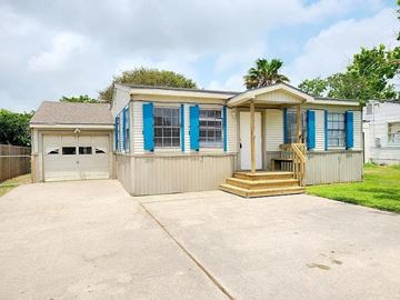 Corpus Christi house for rent - a small house with blue shutters and a driveway
