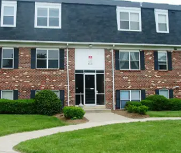 Laplata apartment for rent - a brick building with a lawn in front of it