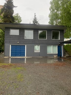 Anchorage apartment for rent - A grey house with a blue garage door.
