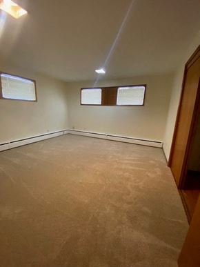 Anchorage apartment for rent - A room with a carpeted floor and two windows.
