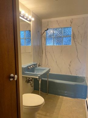Anchorage apartment for rent - A bathroom with a toilet, sink, and bathtub.