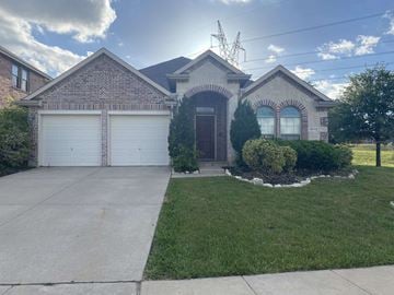 Roanoke house for rent - A house with a brick facade and a white garage door.