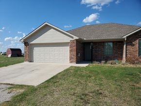 Ponder house for rent - a house with a driveway and a garage door