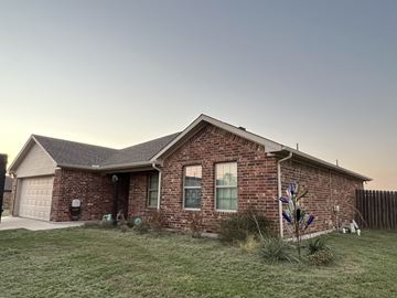 Ponder house for rent - a brick house with a yard in front of it