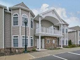 North Babylon apartment for rent - a large house with a balcony and a street light